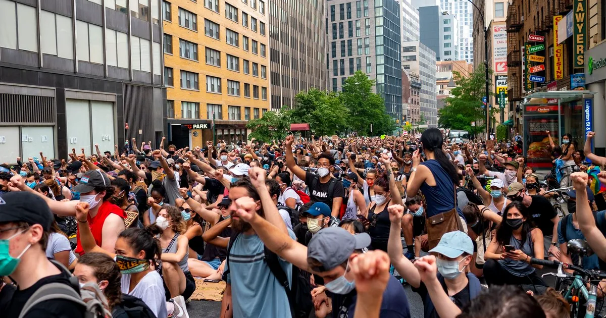 Crowd of demonstrators gathered in a city street during a political rally